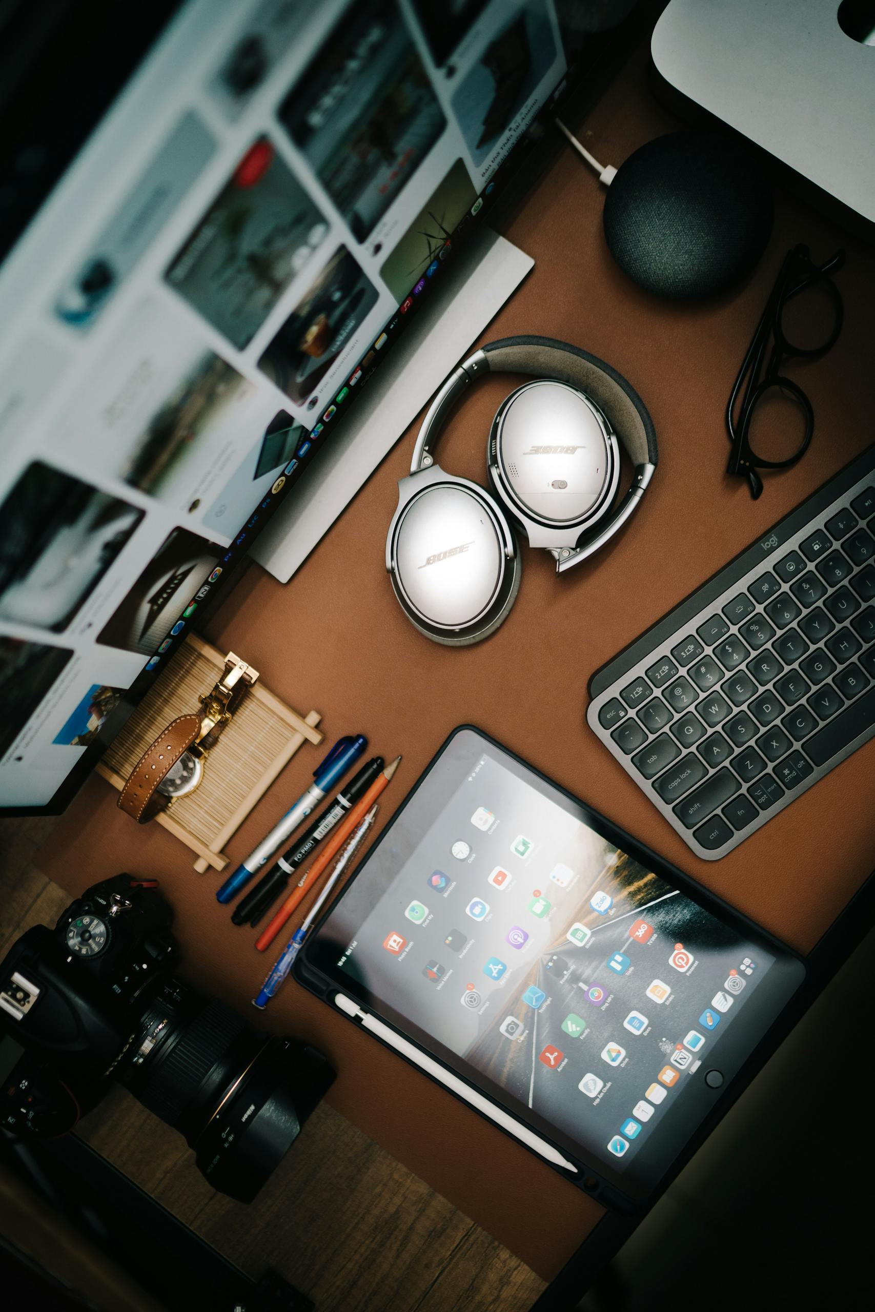 A top view of a modern desk setup with gadgets and accessories, ideal for tech enthusiasts.